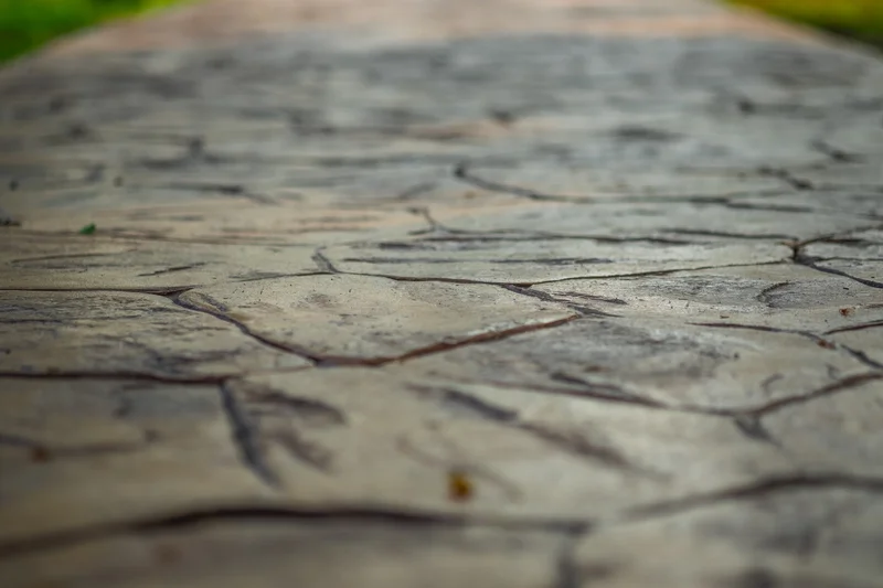 High-quality decorative stamped concrete walkway showing stone-like textures. High-quality decorative stamped concrete walkway showing stone-like textures.