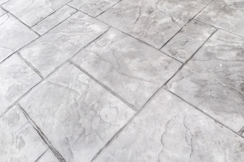 Gray stamped concrete floor with realistic slate tile texture. Gray stamped concrete floor with realistic slate tile texture.