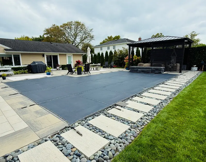 Contemporary pool patio with concrete pavers and river rock borders. Contemporary pool patio with concrete pavers and river rock borders.