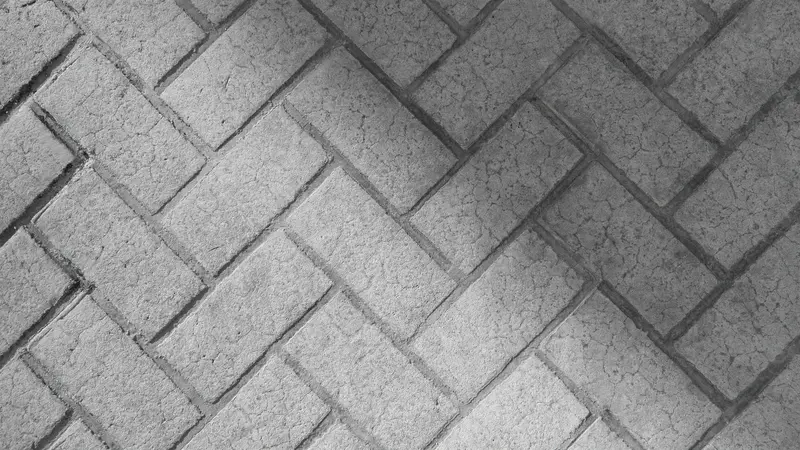 Stamped concrete pathway with a grey herringbone brick pattern. Stamped concrete pathway with a grey herringbone brick pattern.